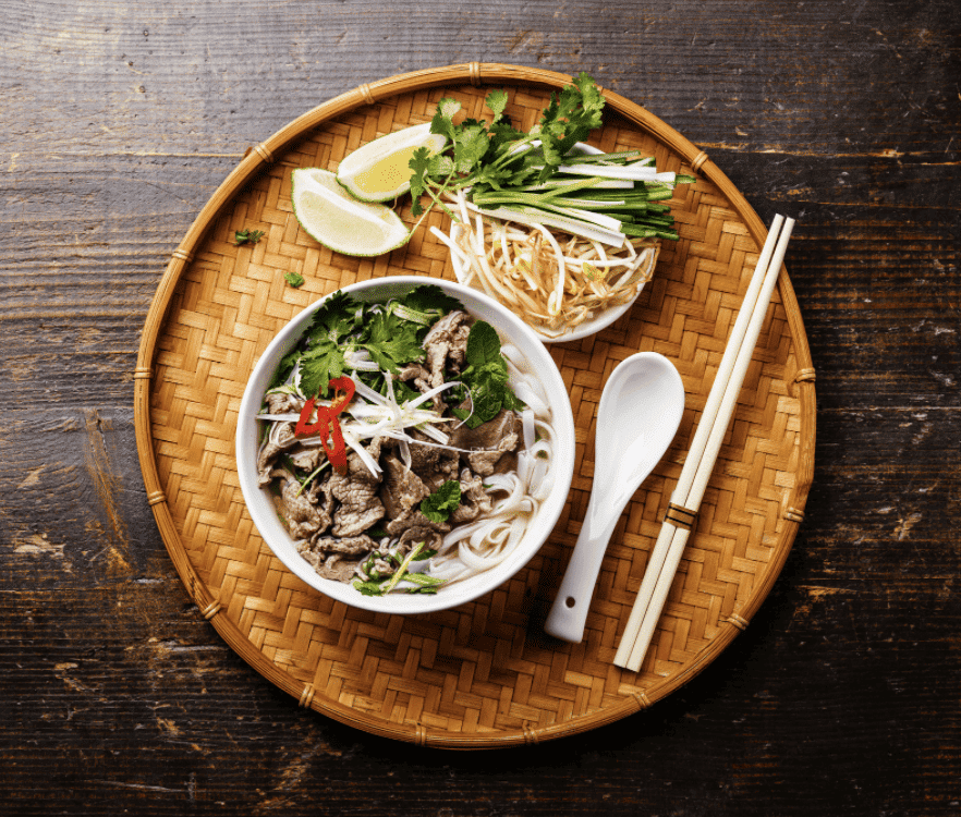 Pho Bo Vietnamese Soup with Beef on Bamboo Tray