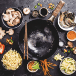 Asian cooking concept: wok surrounded by individual ingredients